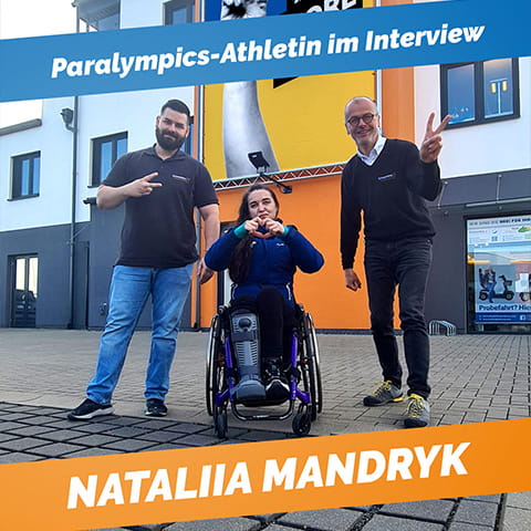 Nataliia Mandryk and two of our technicians pose in front of our headquarters in Rostock