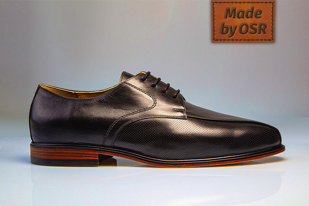 A noble black men's shoe from the side view.